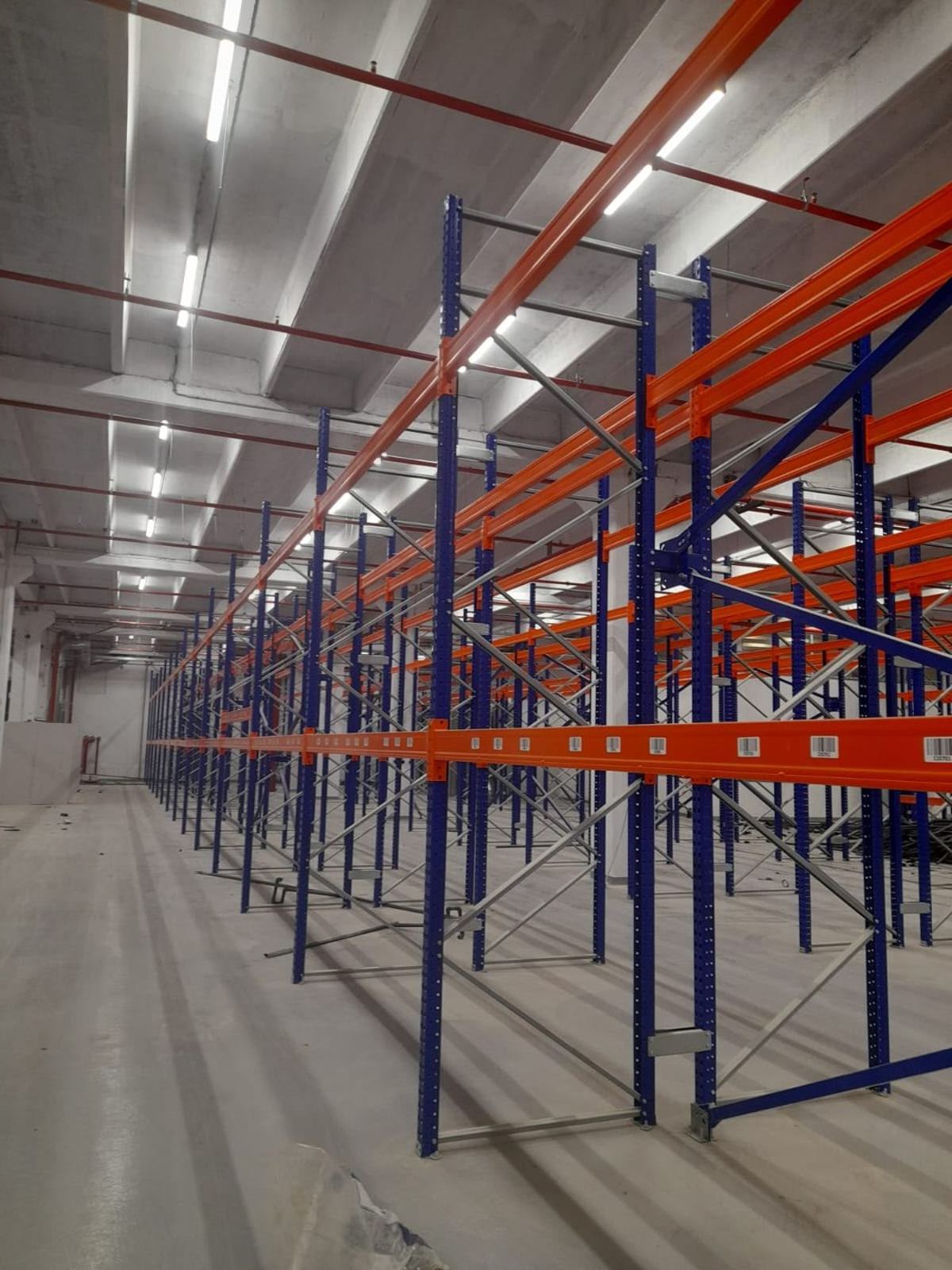 Geniş fabrika deposunda kurulu ikinci el palet rafı hatları